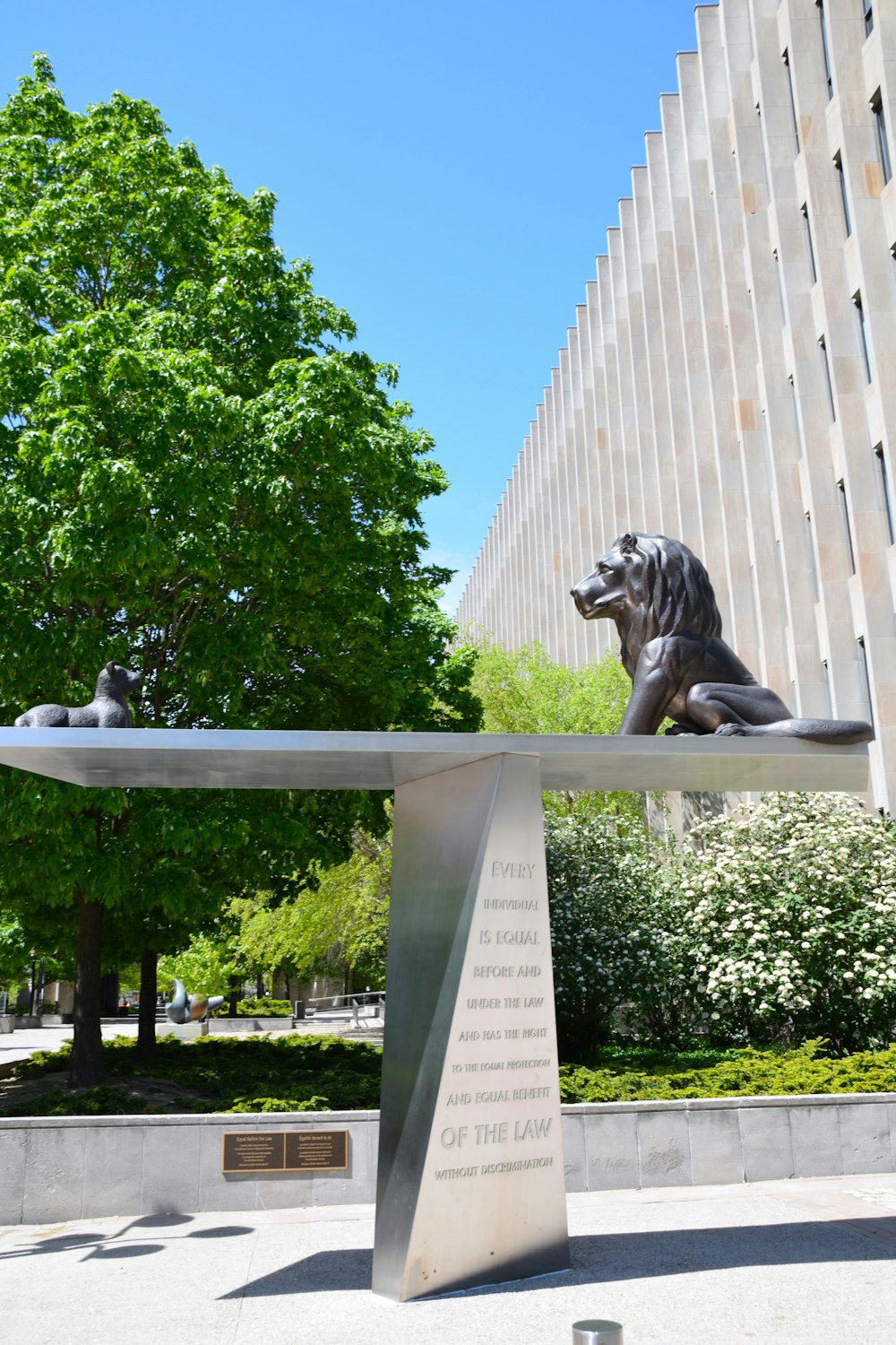 a statue of a dog sitting on top of a bench