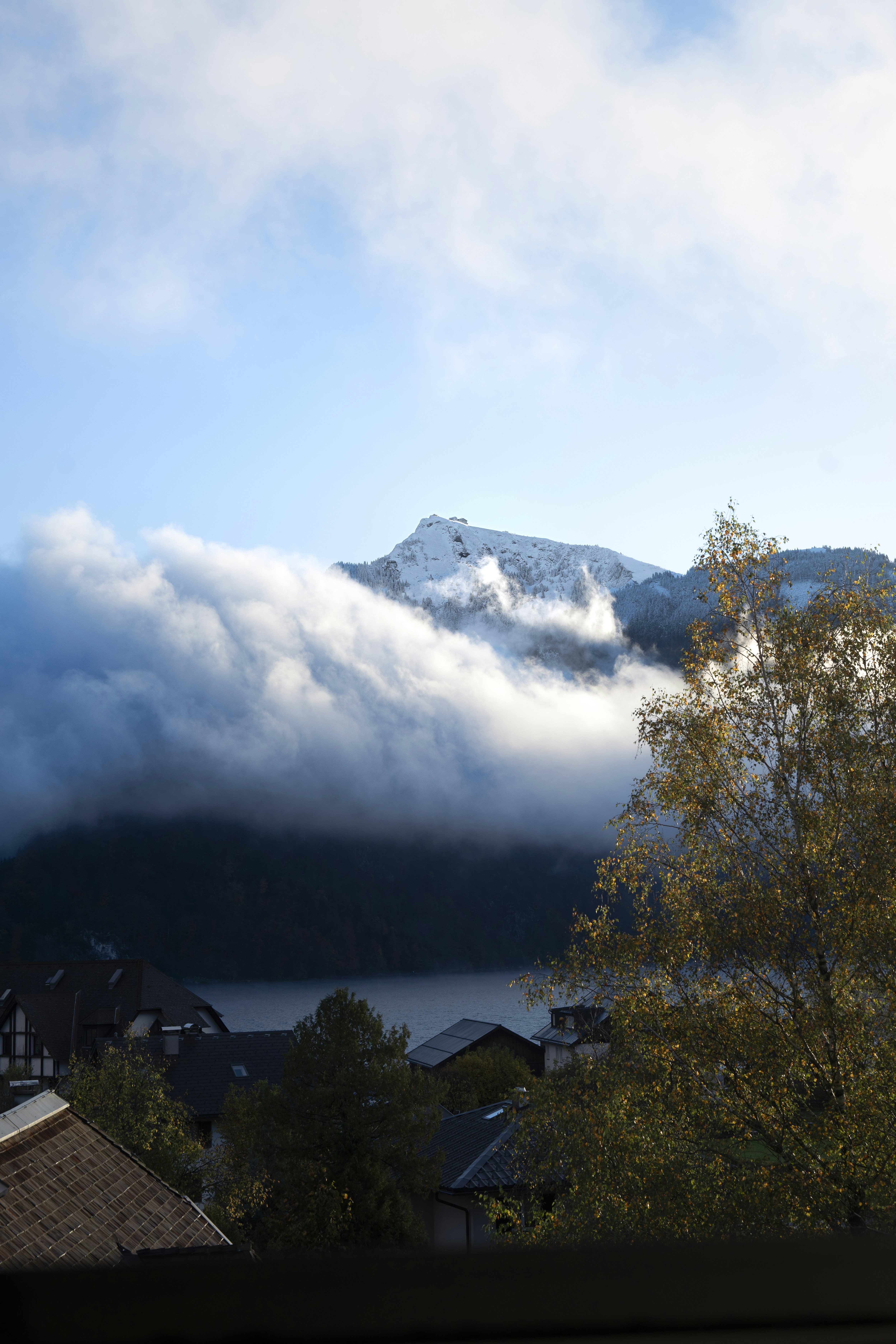 a view of a mountain covered in clouds