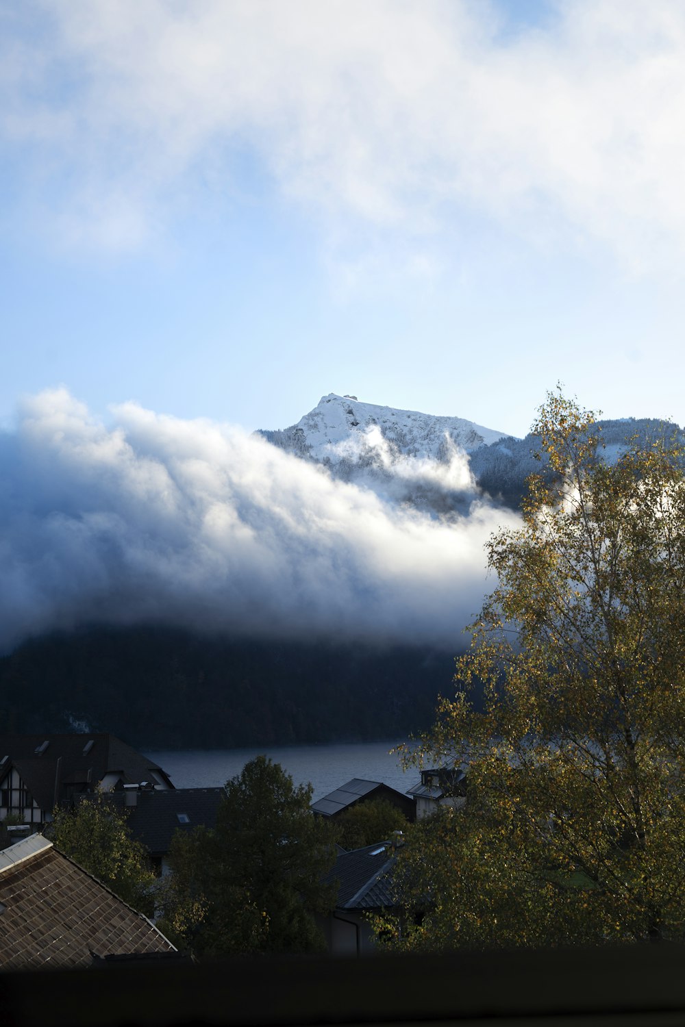 a view of a mountain covered in clouds