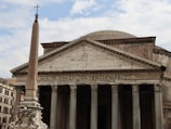 a large building with columns and a cross on top of it