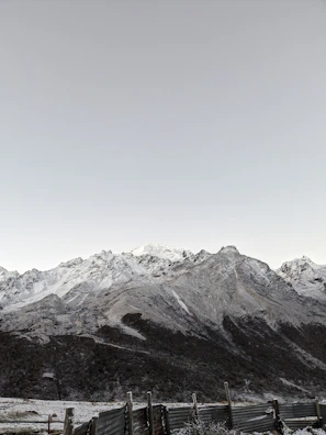 Serene mountain vista visible beyond a sleek, minimal land parcel boundary.
