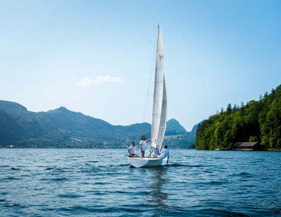 A group of friends enjoying a boat ride on a crystal-clear lake.