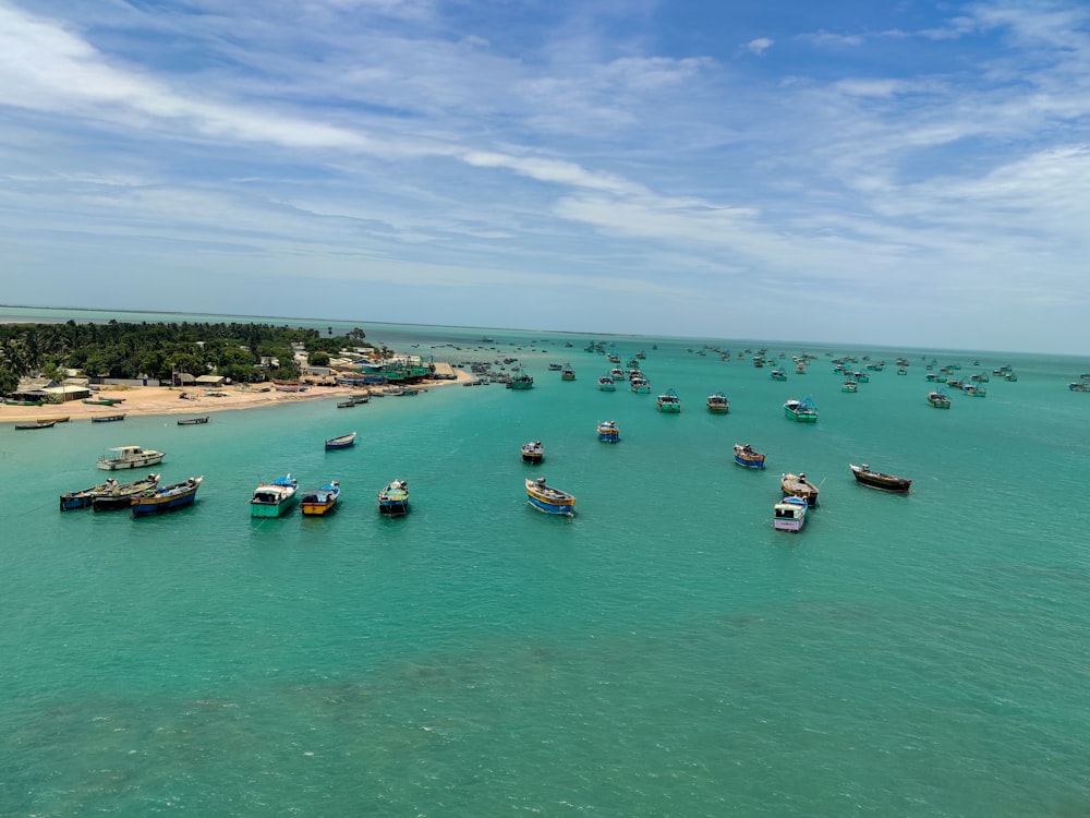 a group of boats floating on top of a body of water