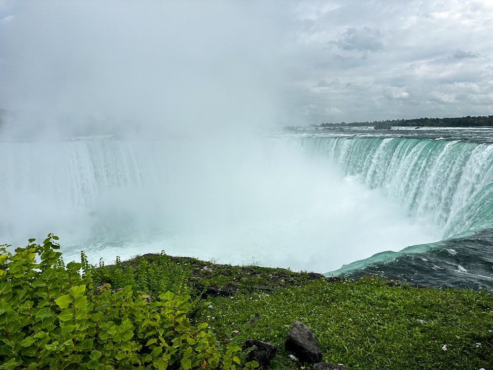 a view of a waterfall from the side of a cliff