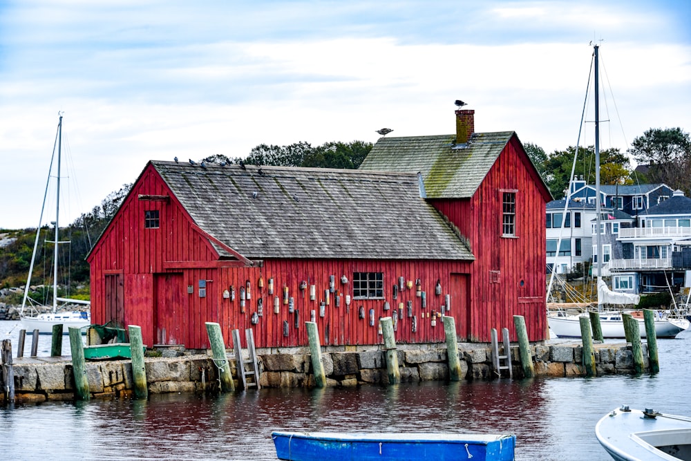 a red building sitting next to a body of water