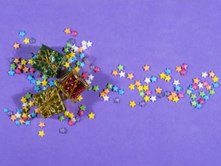 Colorful gift boxes and coins scattered on a table, representing prizes for viewers