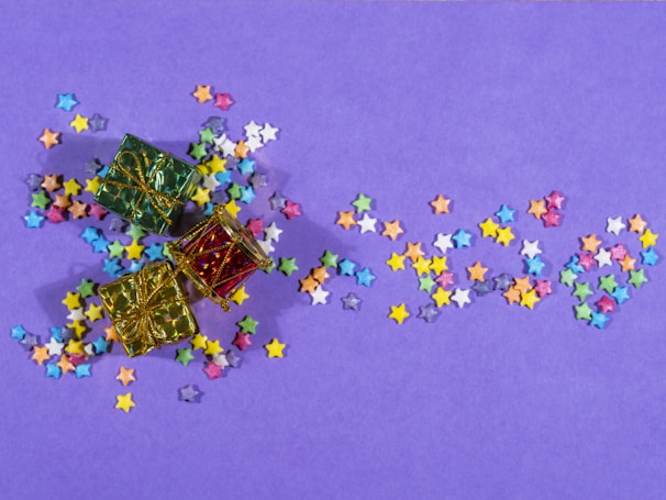 A mystery box with question marks and colorful confetti bursting out.