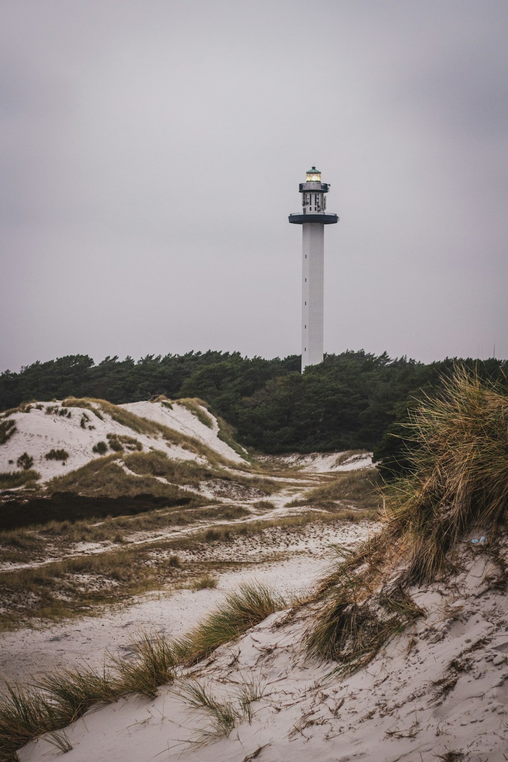 a light house on top of a sandy hill