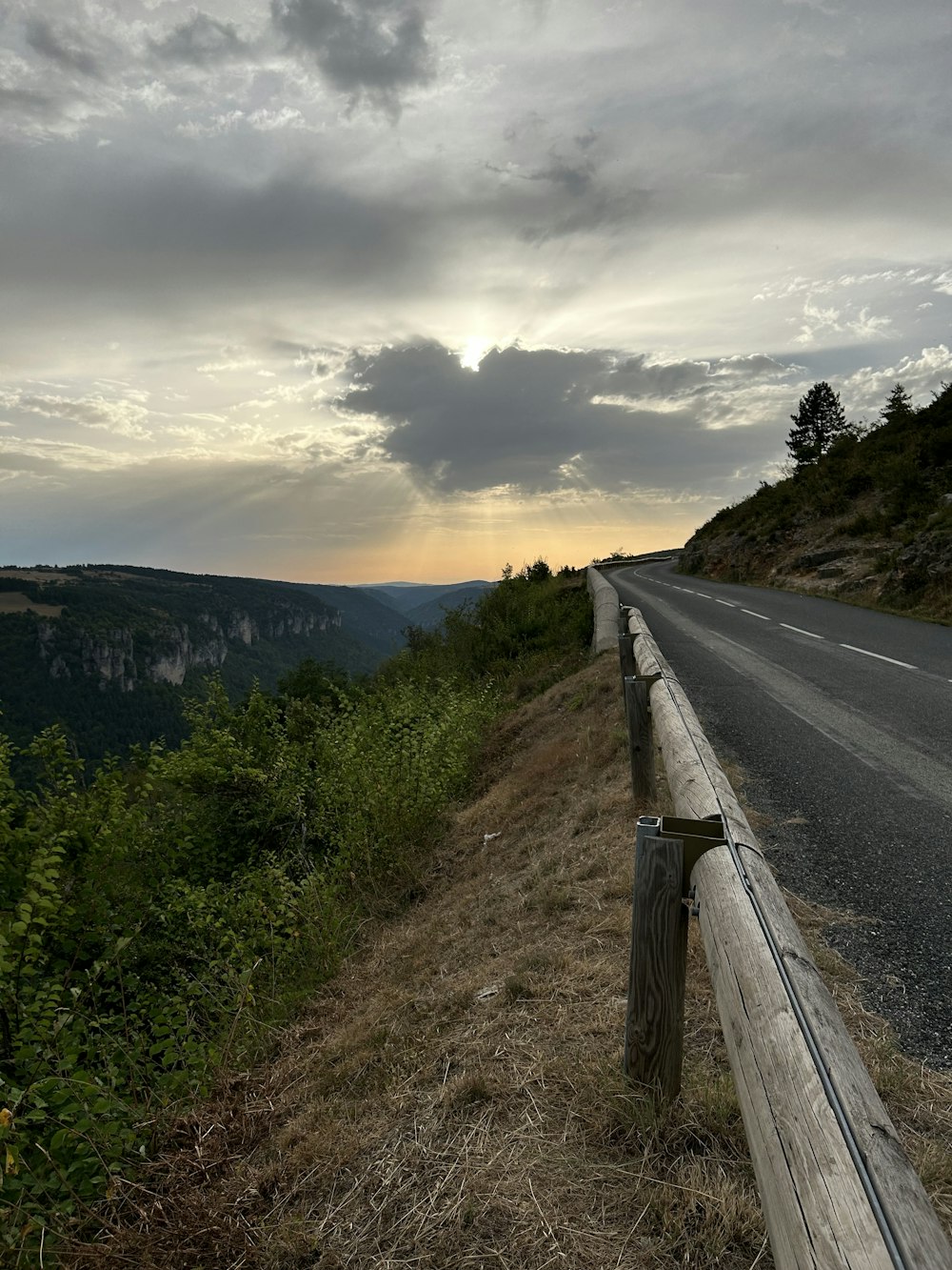 a wooden fence sitting on the side of a road