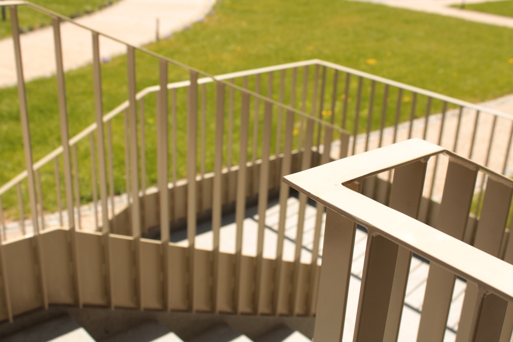 a staircase with a hand rail and a grassy area in the background