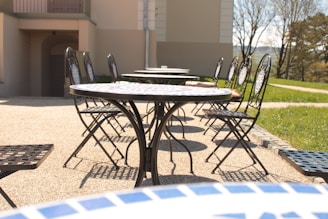 Outdoor patio furnished with comfortable outdoor chairs and tables perfect for gatherings.