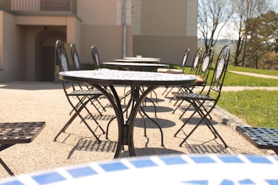 Outdoor patio furnished with comfortable outdoor chairs and tables perfect for gatherings.