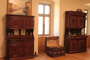 a room with wooden furniture and a painting on the wall