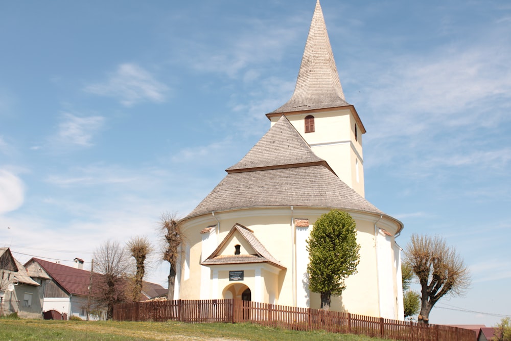 a church with a steeple on a hill
