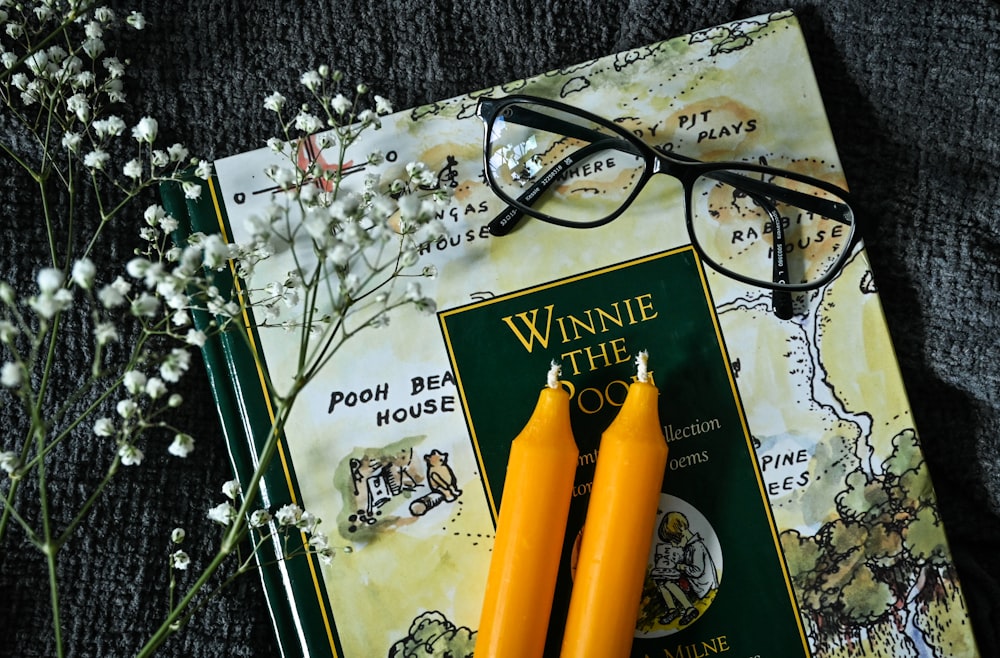 a pair of reading glasses sitting on top of a book