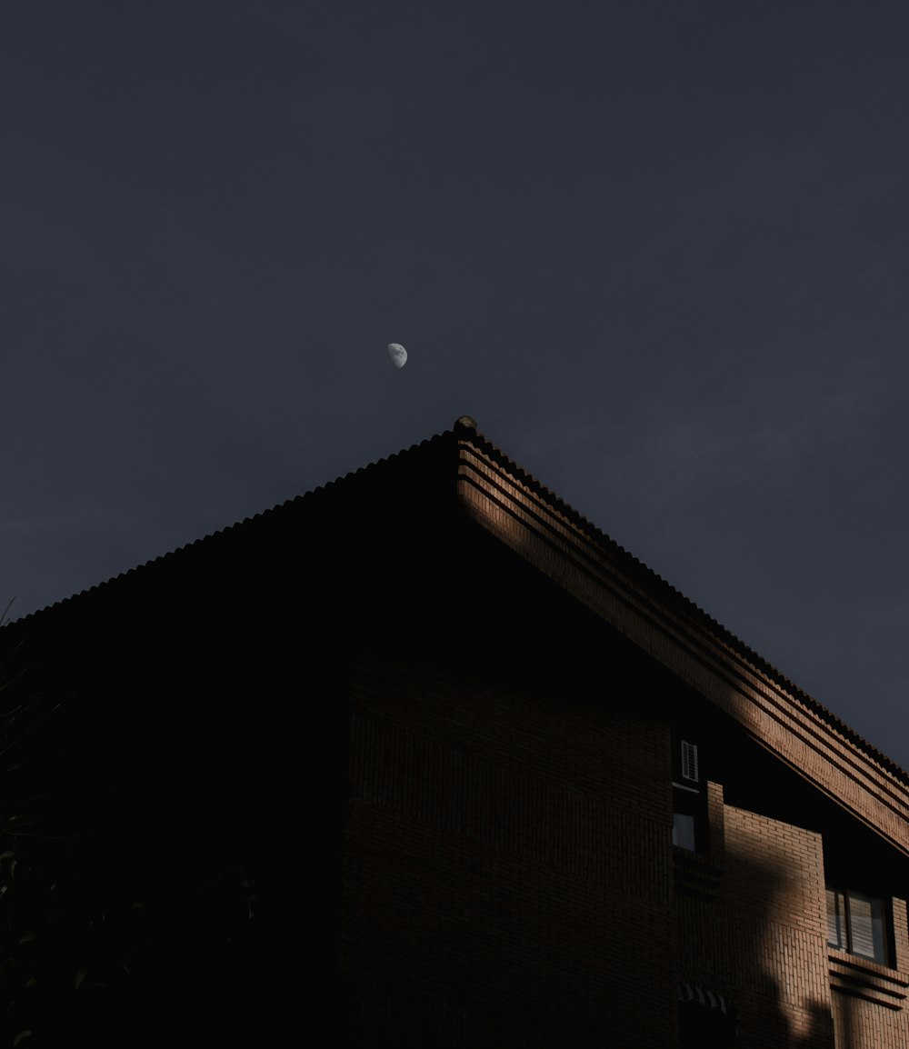 a building with a half moon in the sky