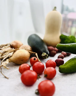 Close-up of fresh regional vegetables and fruits arranged beautifully for a photoshoot in natural light.