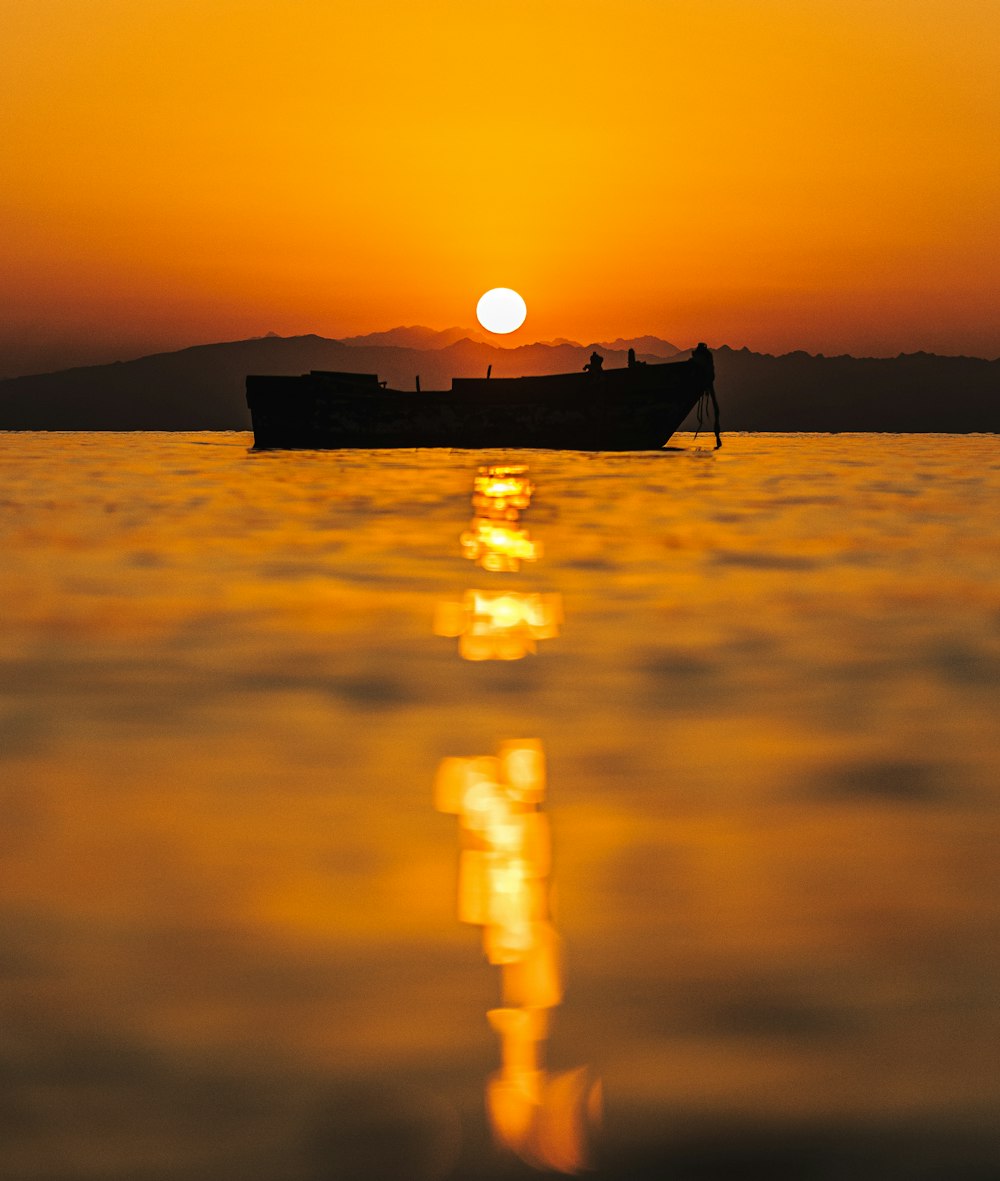 a boat floating on top of a large body of water