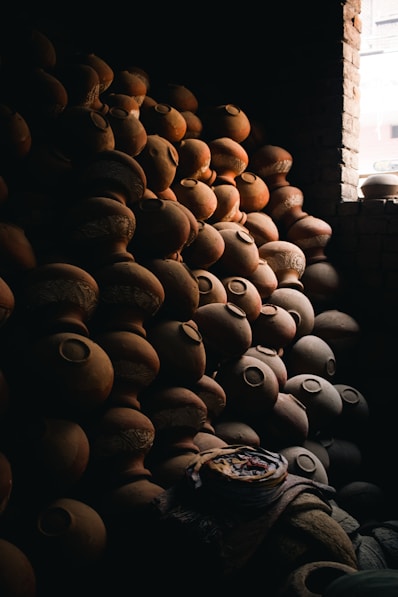 a pile of pottery sitting next to a window