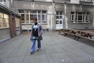 A smiling property manager chatting with tenants in a sunny courtyard.