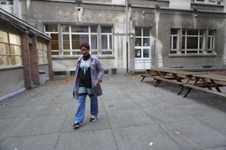 A smiling property manager chatting with tenants in a sunny courtyard.