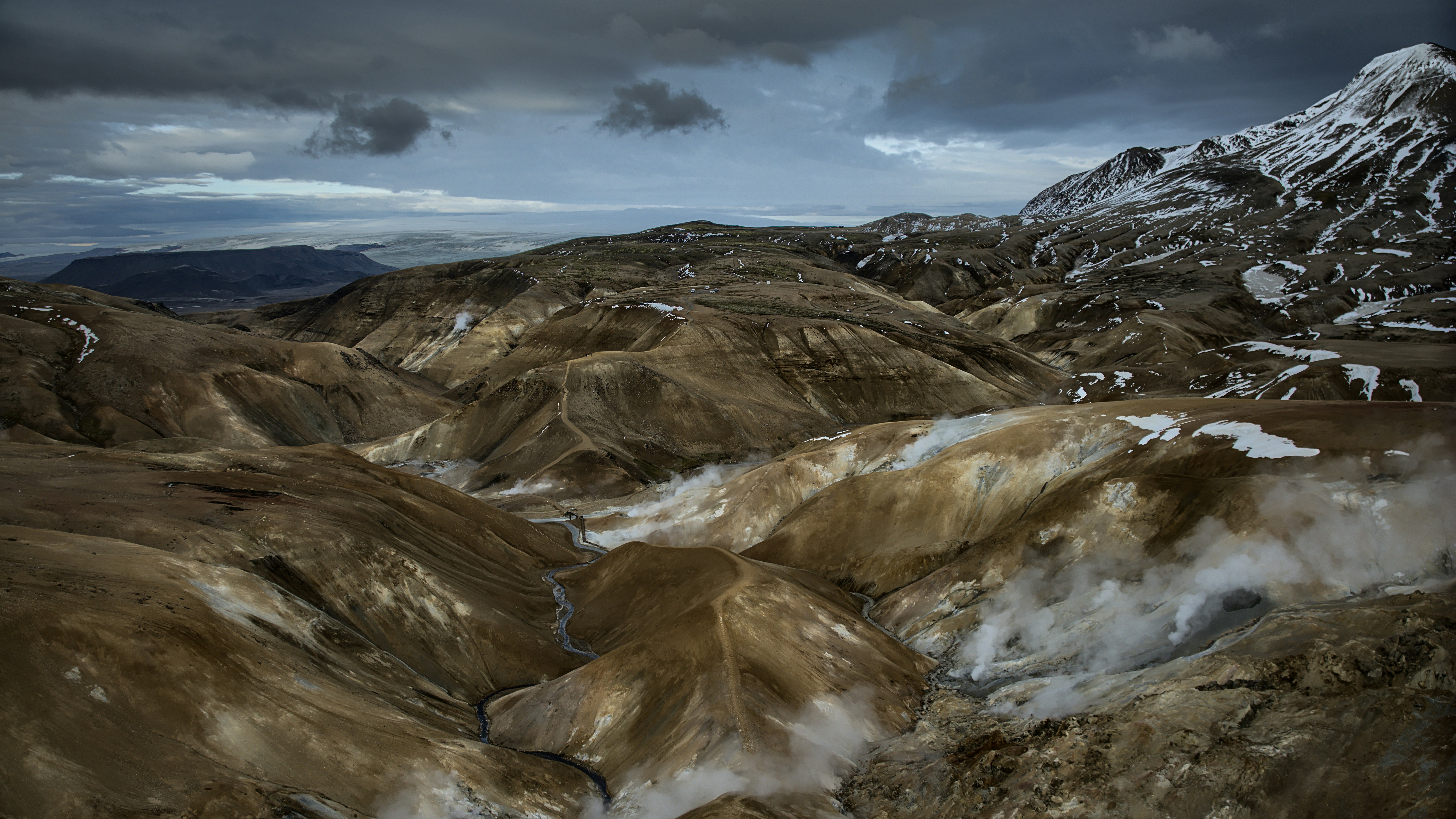 a view of a mountain range covered in snow