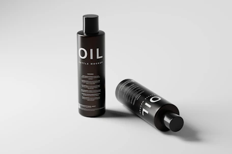 Elegant glass bottles of premium olive oil arranged on a minimalist black surface.
