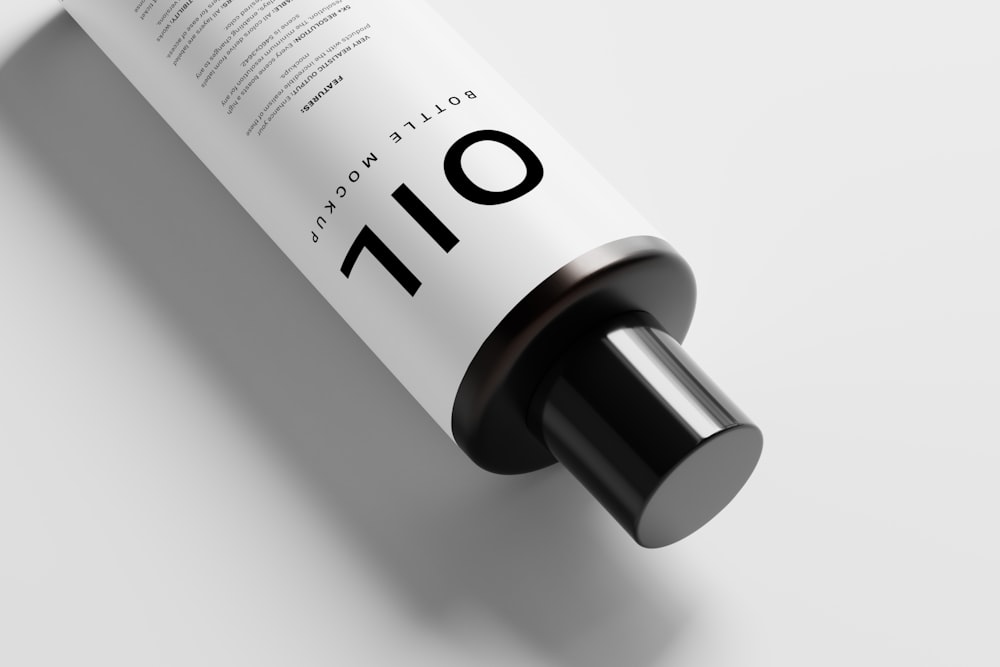 a tube of oil sitting on top of a white table
