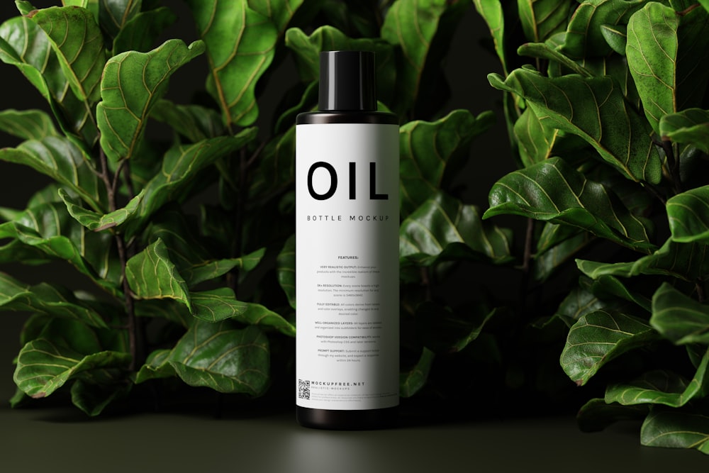 a bottle of oil sitting on top of a lush green plant