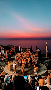 Students practicing traditional dance moves outdoors during sunset