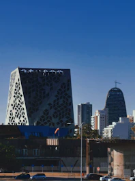 A crisp, modern cityscape photo showing geometric building shapes under a clear sky.