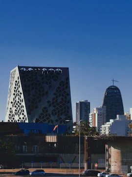 A crisp, modern cityscape photo showing geometric building shapes under a clear sky.