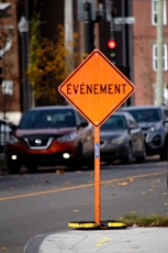 an orange street sign that says an event on it