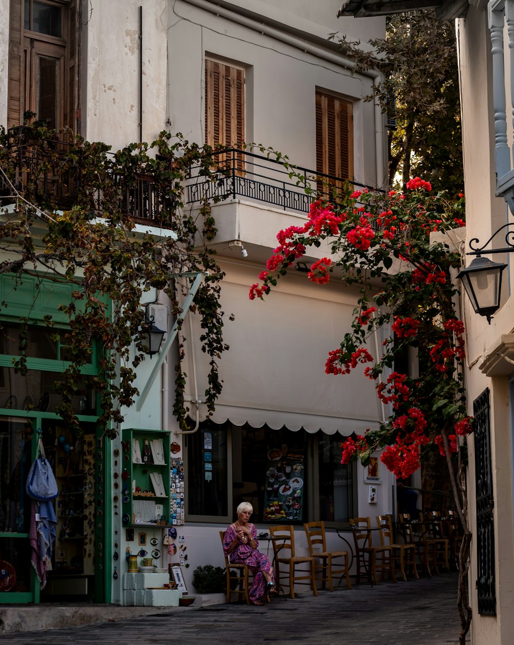 a woman sitting on a chair in front of a building