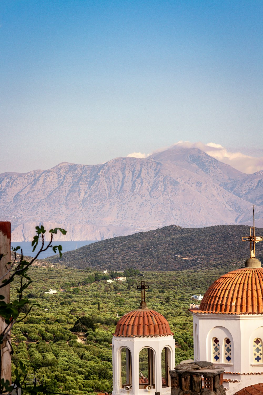 a view of a mountain range with a church in the foreground