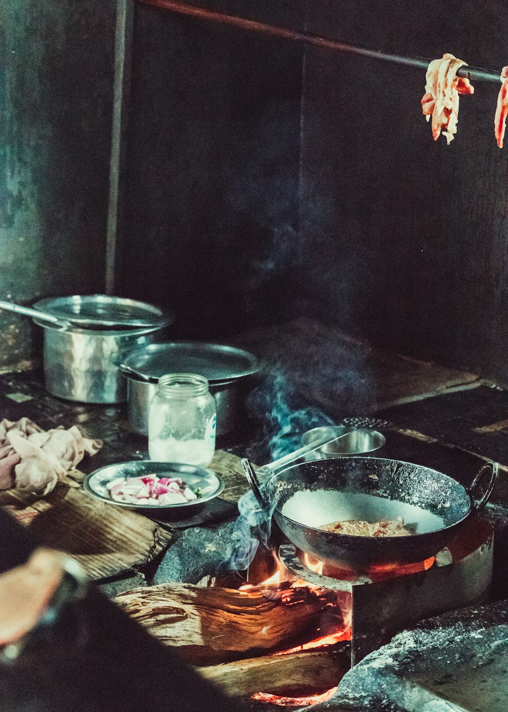 a person cooking food on a stove in a kitchen