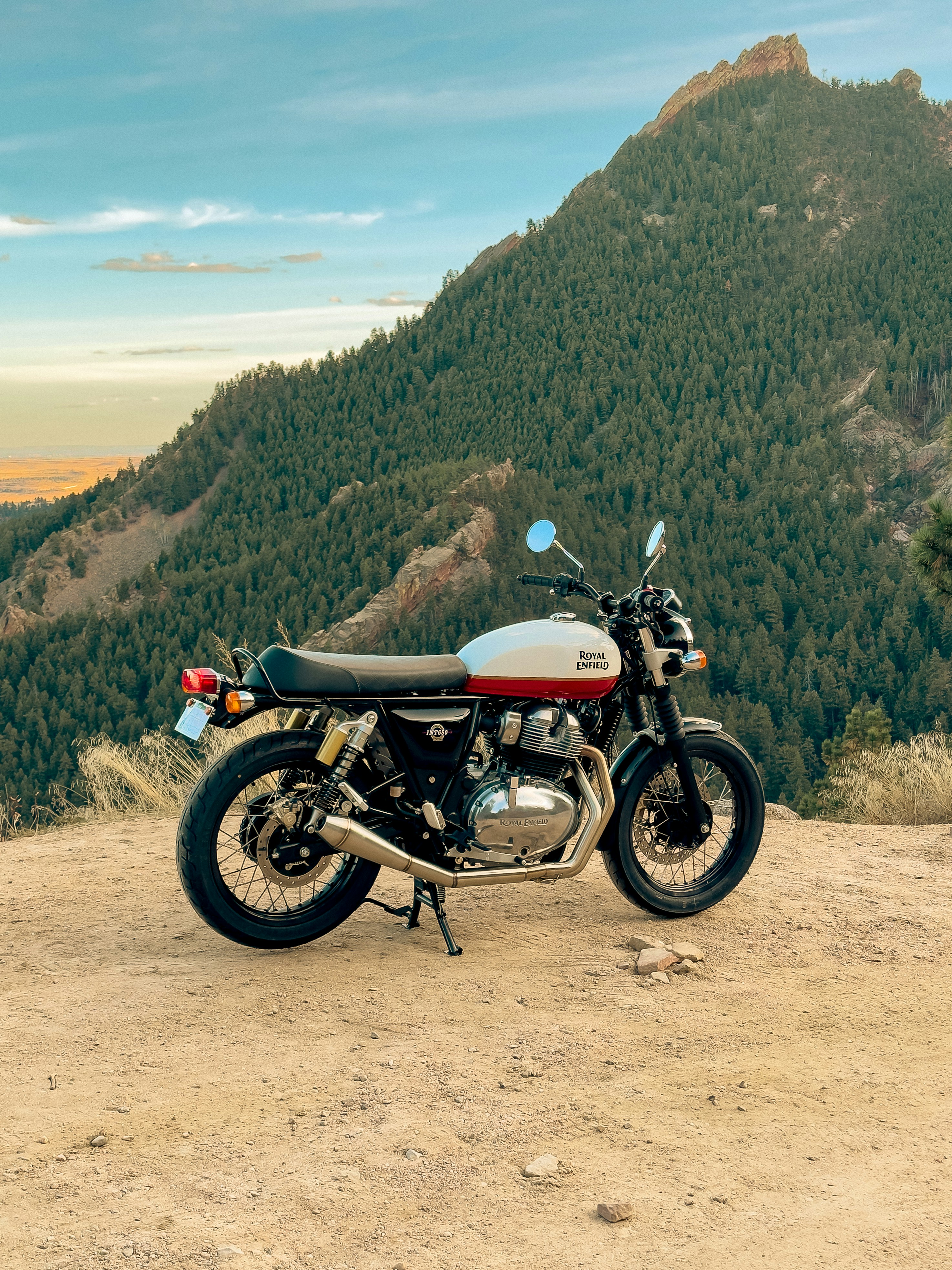 a motorcycle parked on top of a dirt field