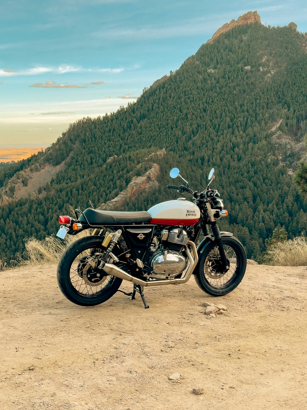 a motorcycle parked on top of a dirt field