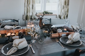 A festive spread featuring colorful ceramic dishes and sparkling glassware arranged for a joyful family dinner.