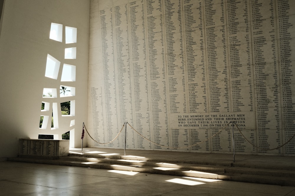 a room with a large wall of names on it