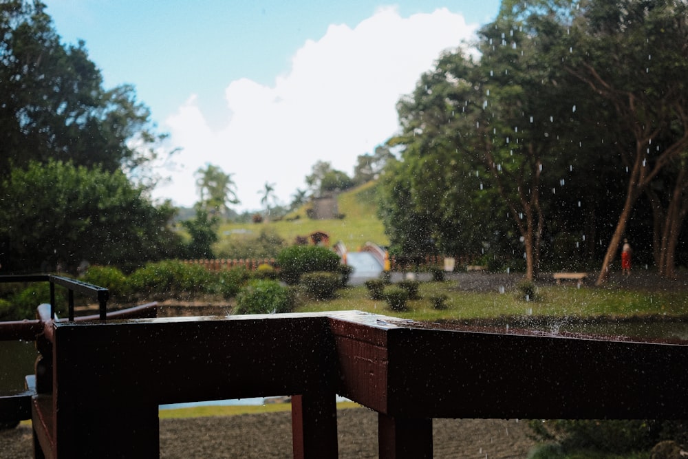 a view of a park through a rainy window