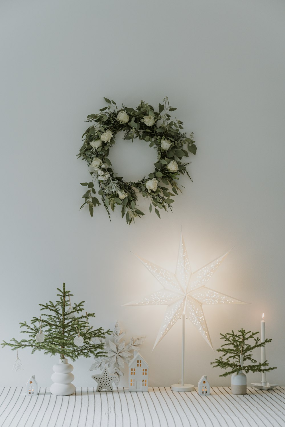 a christmas scene with a star and a wreath