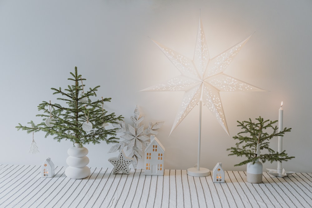 a white christmas tree with a star decoration on top of it