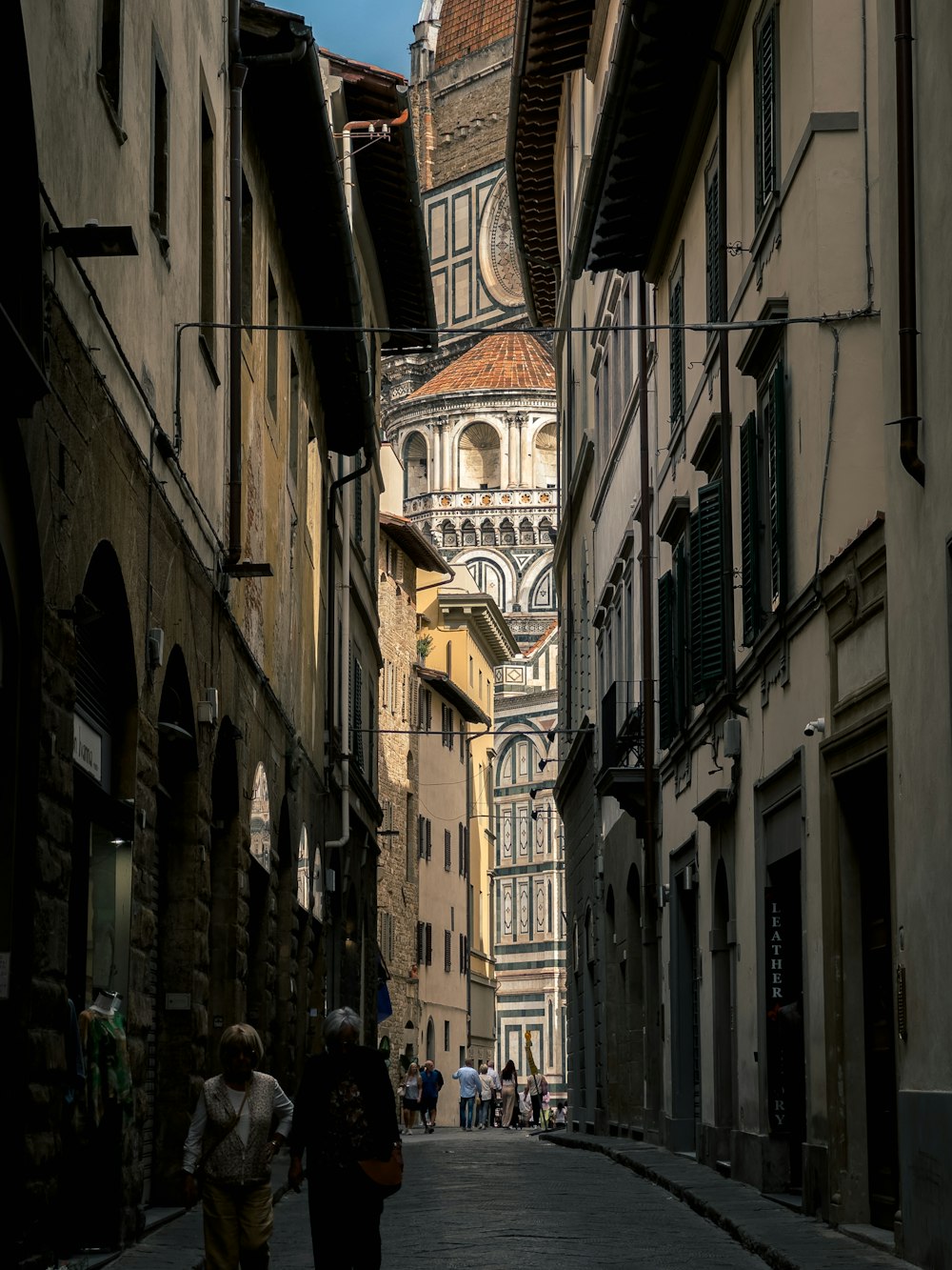 a couple of people that are walking down a street