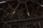 A ceiling with wooden beams and dim lighting houses numerous hanging woven baskets and handicrafts. The shelves display an array of colorful figurines and pottery items. The scene has an eclectic and rustic atmosphere.