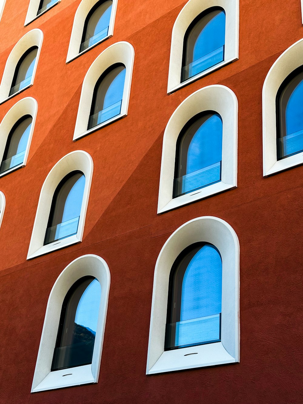 a red building with many windows and a clock