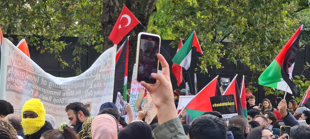 a crowd of people holding up their cell phones