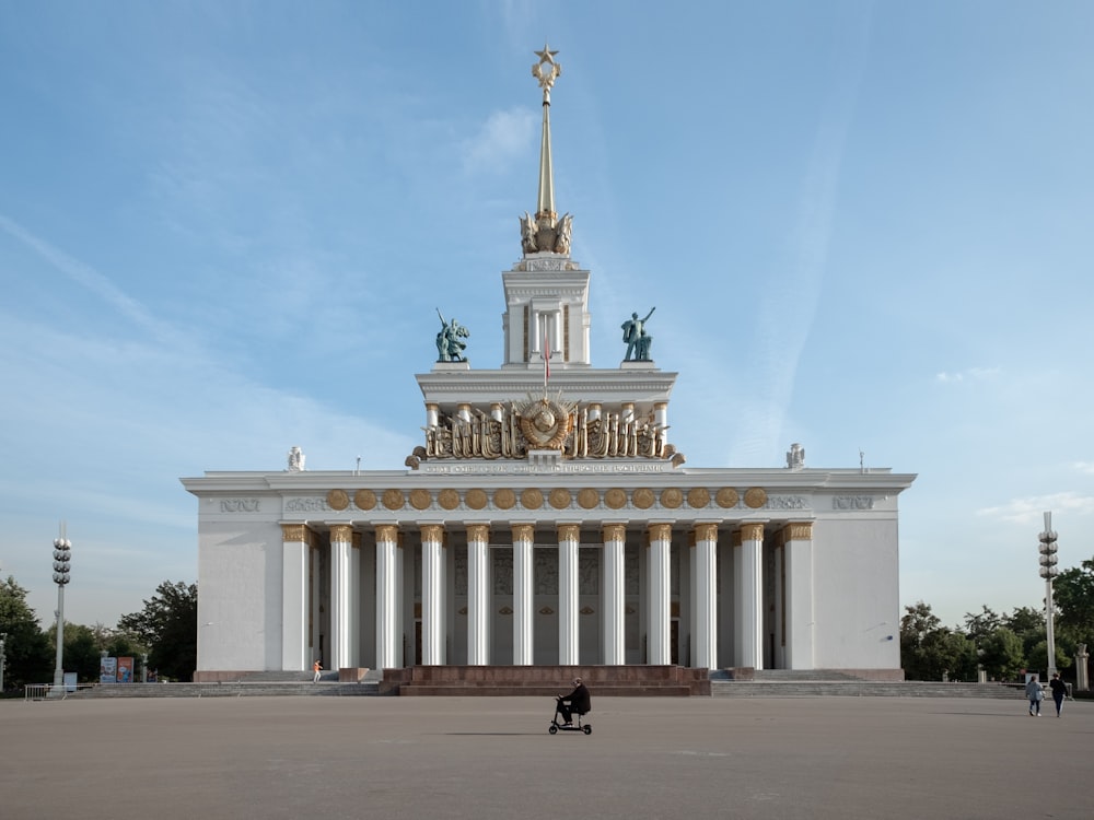 a large white building with statues on top of it