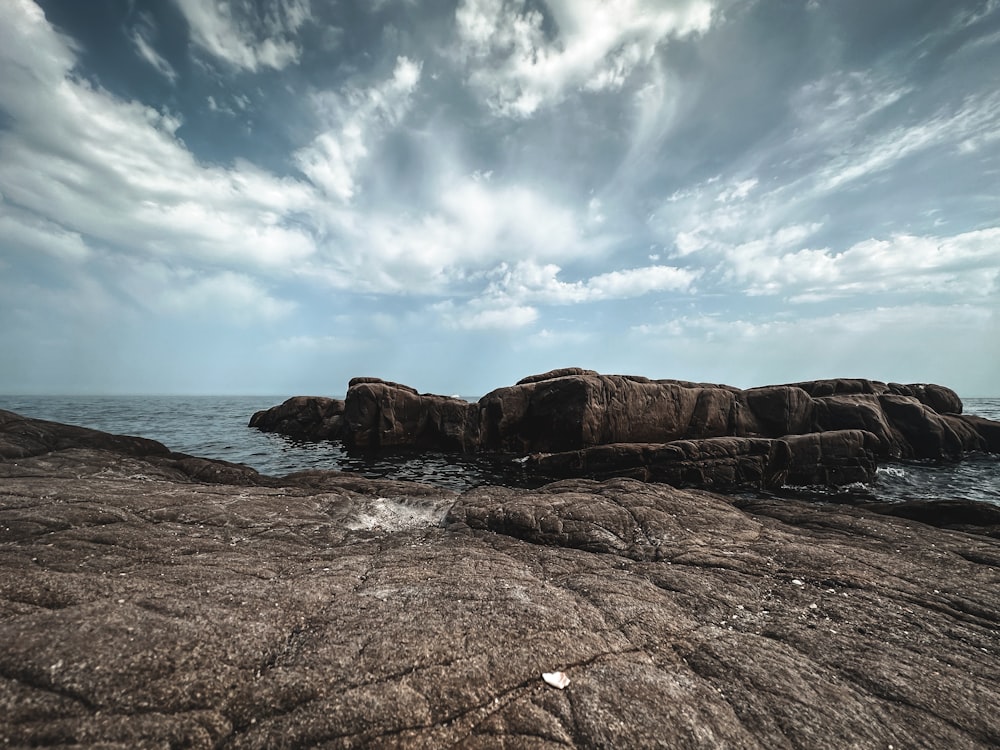 a rock outcropping in the middle of the ocean