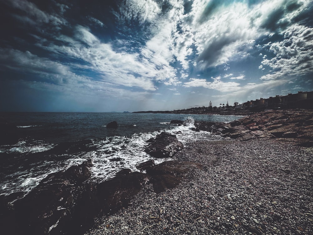 a view of the ocean from a rocky shore